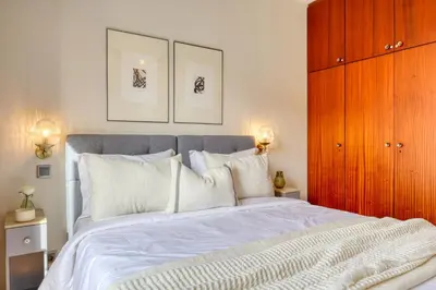 a bedroom with a large bed with white pillows at Refúgio no Funchal, a Home in Madeira in Funchal