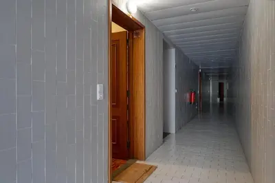 an empty hallway with a door and a tile floor at Refúgio no Funchal, a Home in Madeira in Funchal
