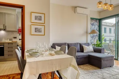 a living room with a table and a couch at Refúgio no Funchal, a Home in Madeira in Funchal
