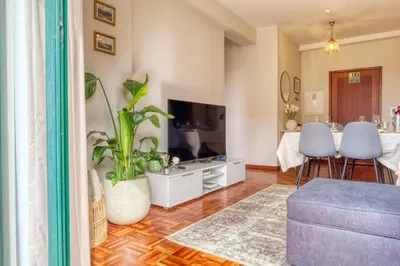 a living room with a couch and a tv at Refúgio no Funchal, a Home in Madeira in Funchal