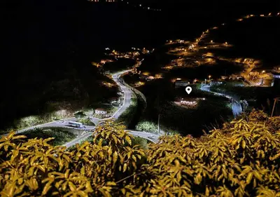a winding road on a hill at night at Banana Lovers - Farm View in Ribeira Brava