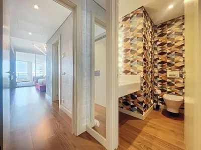 a hallway with a toilet and a wall of wine bottles at MPR The Finnest by Atlantic Holiday in Funchal