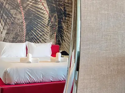 a bed with white pillows in a room at MPR The Finnest by Atlantic Holiday in Funchal