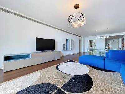 a living room with a blue couch and a tv at MPR The Finnest by Atlantic Holiday in Funchal