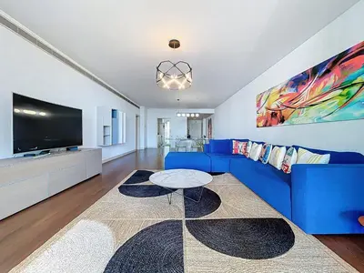a living room with a blue couch and a tv at MPR The Finnest by Atlantic Holiday in Funchal