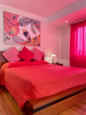 a bedroom with a red bed with a red blanket at Funchal Center Apartment in Funchal