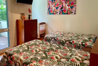 a bedroom with two beds and a dresser with a bedspread at Funchal Center Apartment in Funchal
