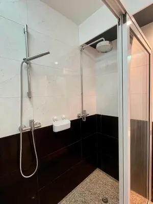 a bathroom with a shower with a glass door at Funchal Center Apartment in Funchal
