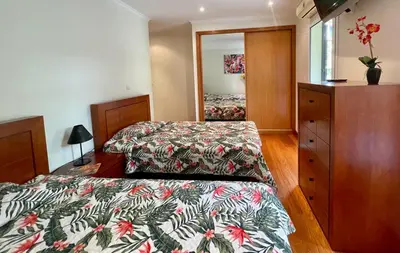 a bedroom with two beds and a dresser at Funchal Center Apartment in Funchal