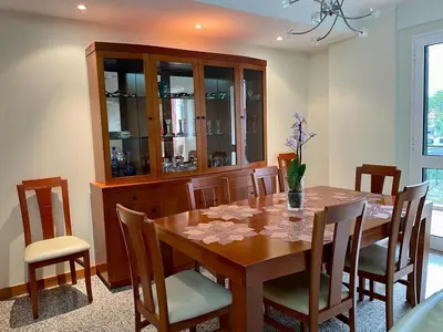 a dining room with a wooden table and chairs at Funchal Center Apartment in Funchal