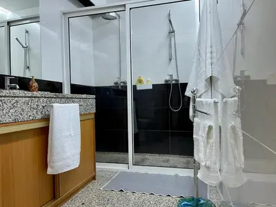 a bathroom with a shower with a glass door at Funchal Center Apartment in Funchal