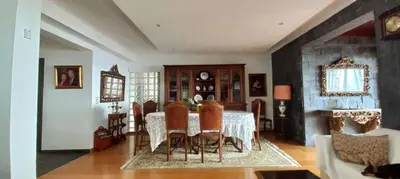 a room with a bed and a pink couch at Lido ocean front penthouse in Funchal
