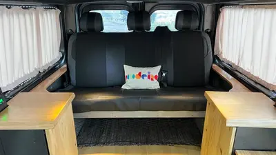 a couch in the back of a van with two benches at Geko camper in Funchal