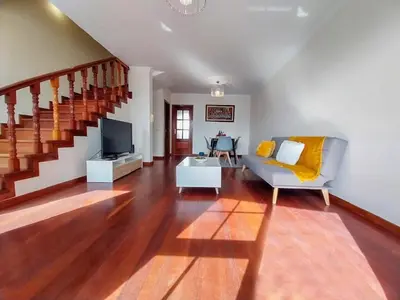 a bedroom with a bed and a window and wooden cabinets at Amazing View in Santa Cruz