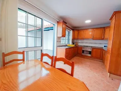 a kitchen with a wooden table and a large window at Amazing View in Santa Cruz