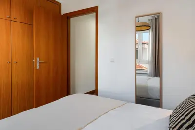 a bedroom with a bed and a mirror at Santiago House by An Island Apart in Funchal