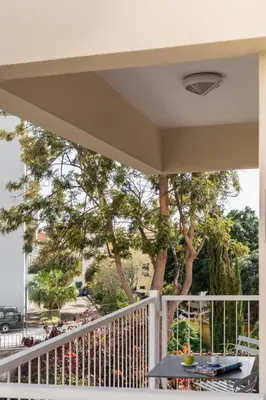 a balcony with a white fence and trees at Santiago House by An Island Apart in Funchal
