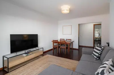 a living room with a couch and a flat screen tv at Santiago House by An Island Apart in Funchal