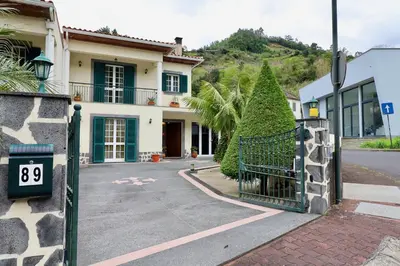 a house with a gate in front of a street at Villa Rose by AnaLodges in Senhora do Rosário