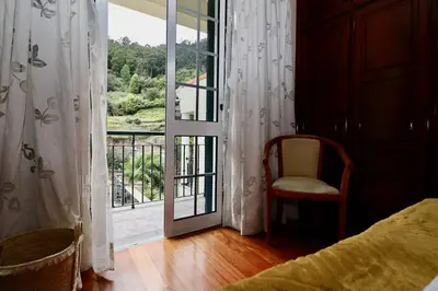 a bedroom with a door open to a balcony at Villa Rose by AnaLodges in Senhora do Rosário