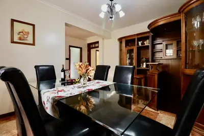 a dining room with a glass table and black chairs at Villa Rose by AnaLodges in Senhora do Rosário