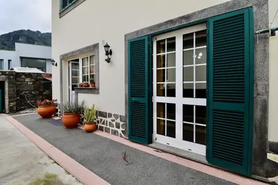 a door with green shutters on a building at Villa Rose by AnaLodges in Senhora do Rosário