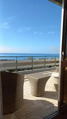 a living room with a couch and a television at Funchal Lido Duplex in Funchal