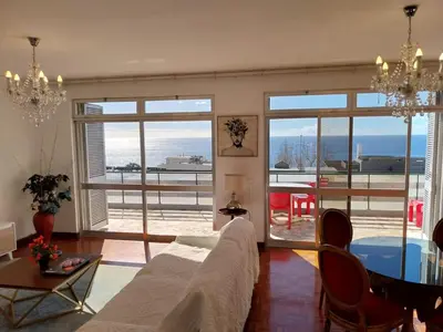 a living room with a couch and a table at Funchal Lido Duplex in Funchal