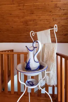 a vase sitting on a table next to a chair at Portas da Levada A by Rent-a-key in São Vicente