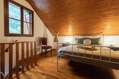 a bedroom with a bed and a wooden ceiling at Portas da Levada A by Rent-a-key in São Vicente
