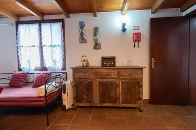 a room with a bed and a wooden dresser at Portas da Levada A by Rent-a-key in São Vicente