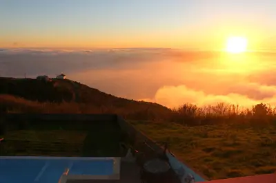 a view of the sun rising above the clouds at Madeira Native Motion Apartment in Ponta do Pargo