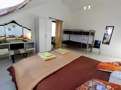 a bedroom with a large bed with two bunk beds at Madeira Native Motion Apartment in Ponta do Pargo