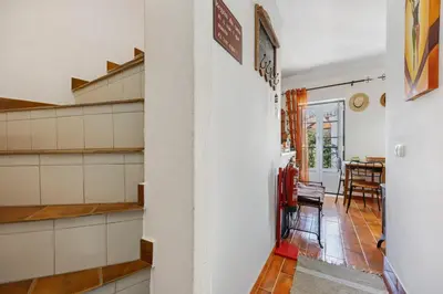 a hallway with shelves and a dining room at Burgau - A Casa dos Avós in Burgau