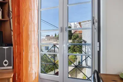 a window with a view of a city at Burgau - A Casa dos Avós in Burgau