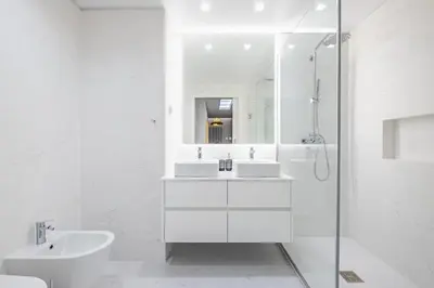 a white bathroom with two sinks and a shower at Oceans Whisper by Homie in Funchal