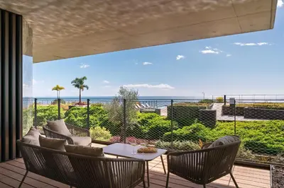 a patio with a table and chairs and a view of the ocean at Luxury in Funchal - Savoy Monumentalis II in Funchal