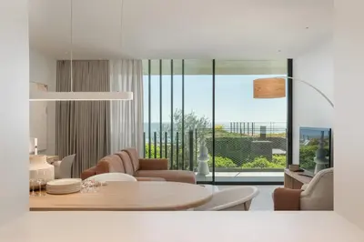 a white living room with a table and chairs at Luxury in Funchal - Savoy Monumentalis II in Funchal