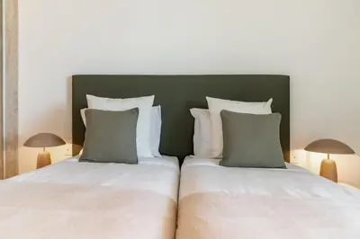 a bedroom with two beds and two lamps at Luxury in Funchal - Savoy Monumentalis II in Funchal