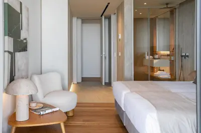 a bedroom with a bed and a chair and a table at Luxury in Funchal - Savoy Monumentalis II in Funchal