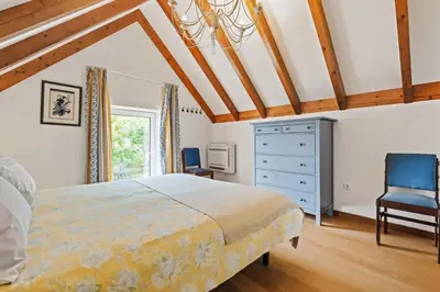 a bedroom with a bed and a blue dresser at Quinta da Fonte in Prazeres