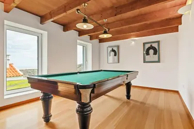 a pool table in a room with wooden ceilings at Quinta da Fonte in Prazeres