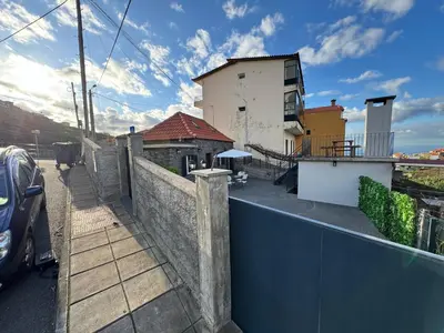 a view of a house with a fence at Jose CL in Estreito de Câmara de Lobos