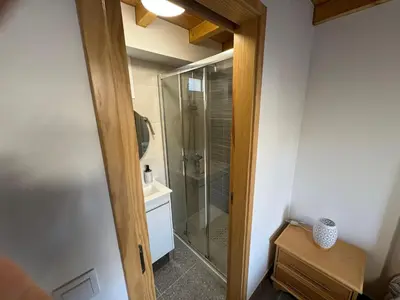 a bathroom with a shower with a glass door at Jose CL in Estreito de Câmara de Lobos
