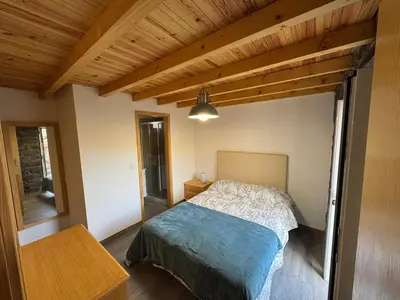 a bedroom with a bed and a wooden ceiling at Jose CL in Estreito de Câmara de Lobos