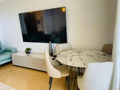 a dining room with a table and chairs and a mirror at Villa Michelangelo in Câmara de Lobos