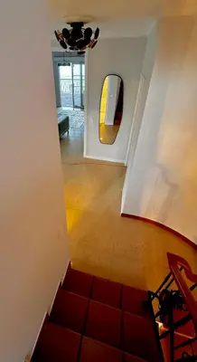 a hallway with a staircase and a mirror on the wall at Villa Michelangelo in Câmara de Lobos