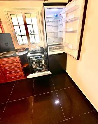 an empty refrigerator with its door open in a kitchen at Villa Michelangelo in Câmara de Lobos