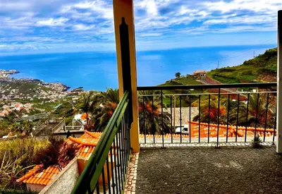 a balcony with a view of the ocean at Villa Michelangelo in Câmara de Lobos