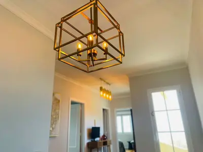 a chandelier hanging from a ceiling in a room at Villa Michelangelo in Câmara de Lobos